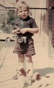 Mike with camera as a baby